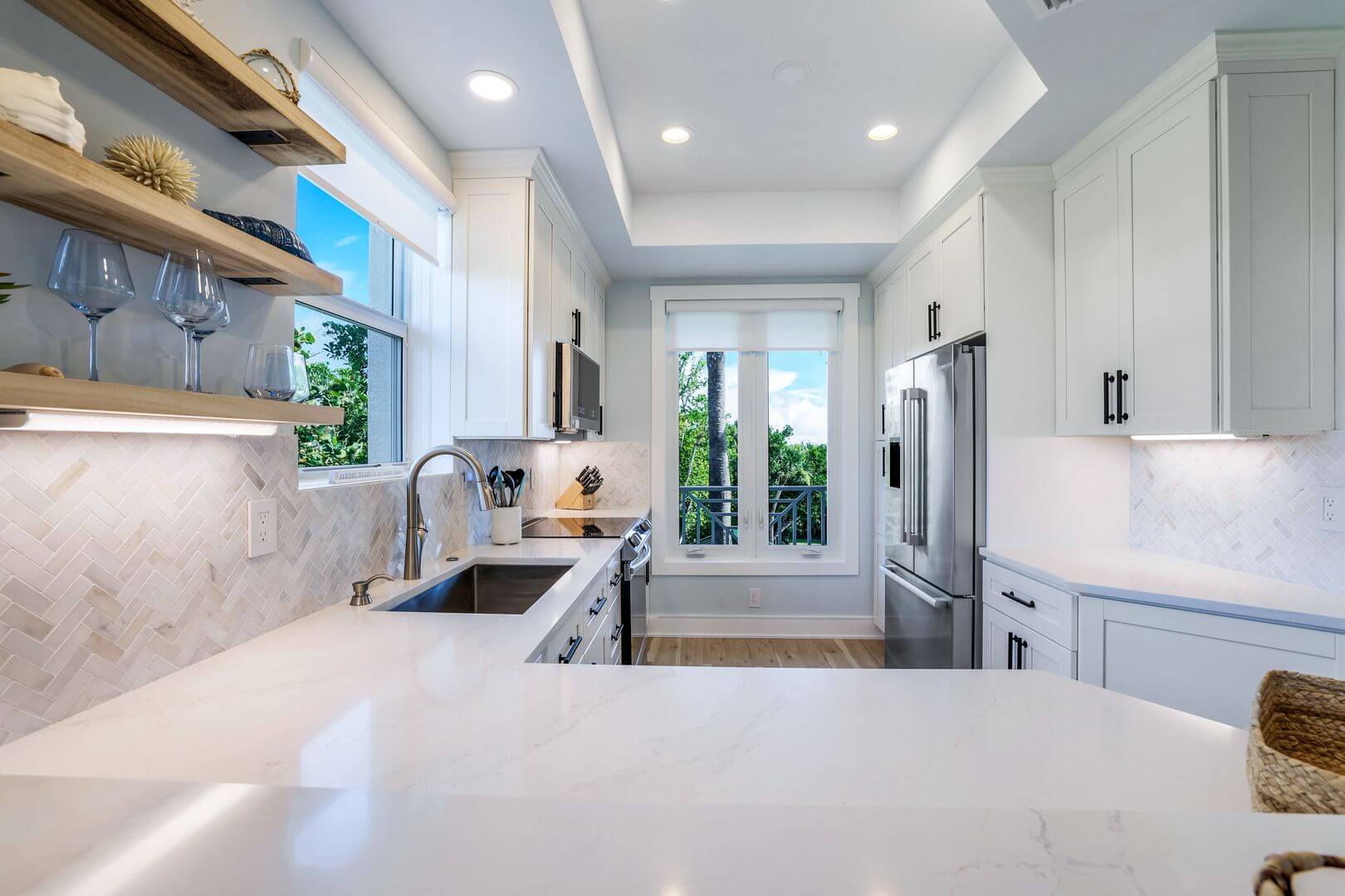 Modern kitchen with white cabinets and countertops.