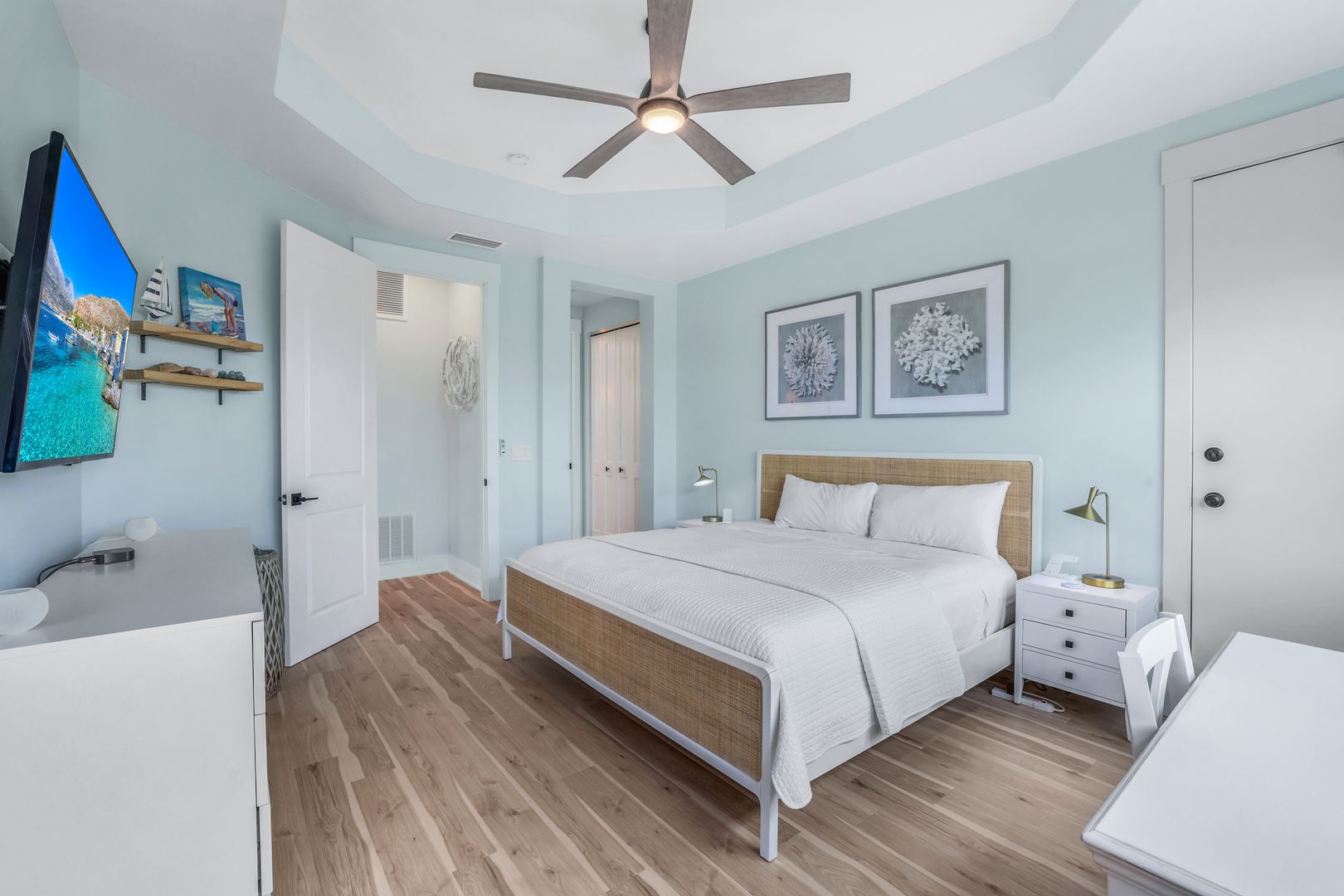 Bright modern bedroom with wooden floor.