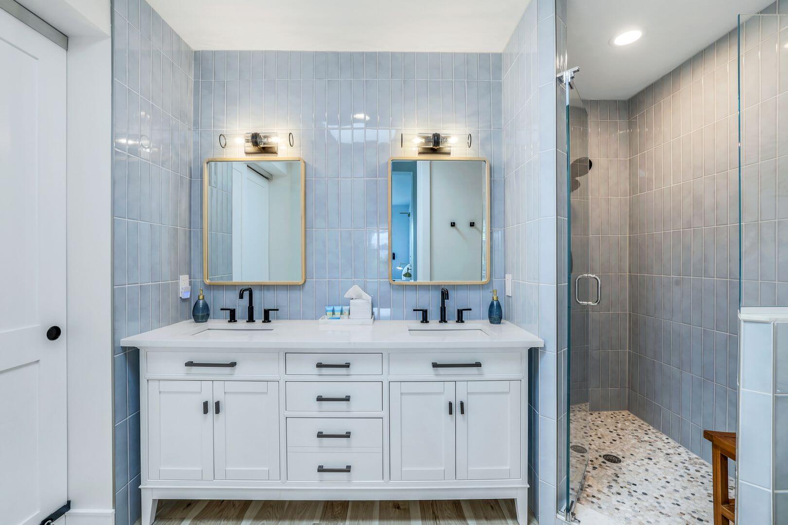 Modern bathroom with double vanity and shower.