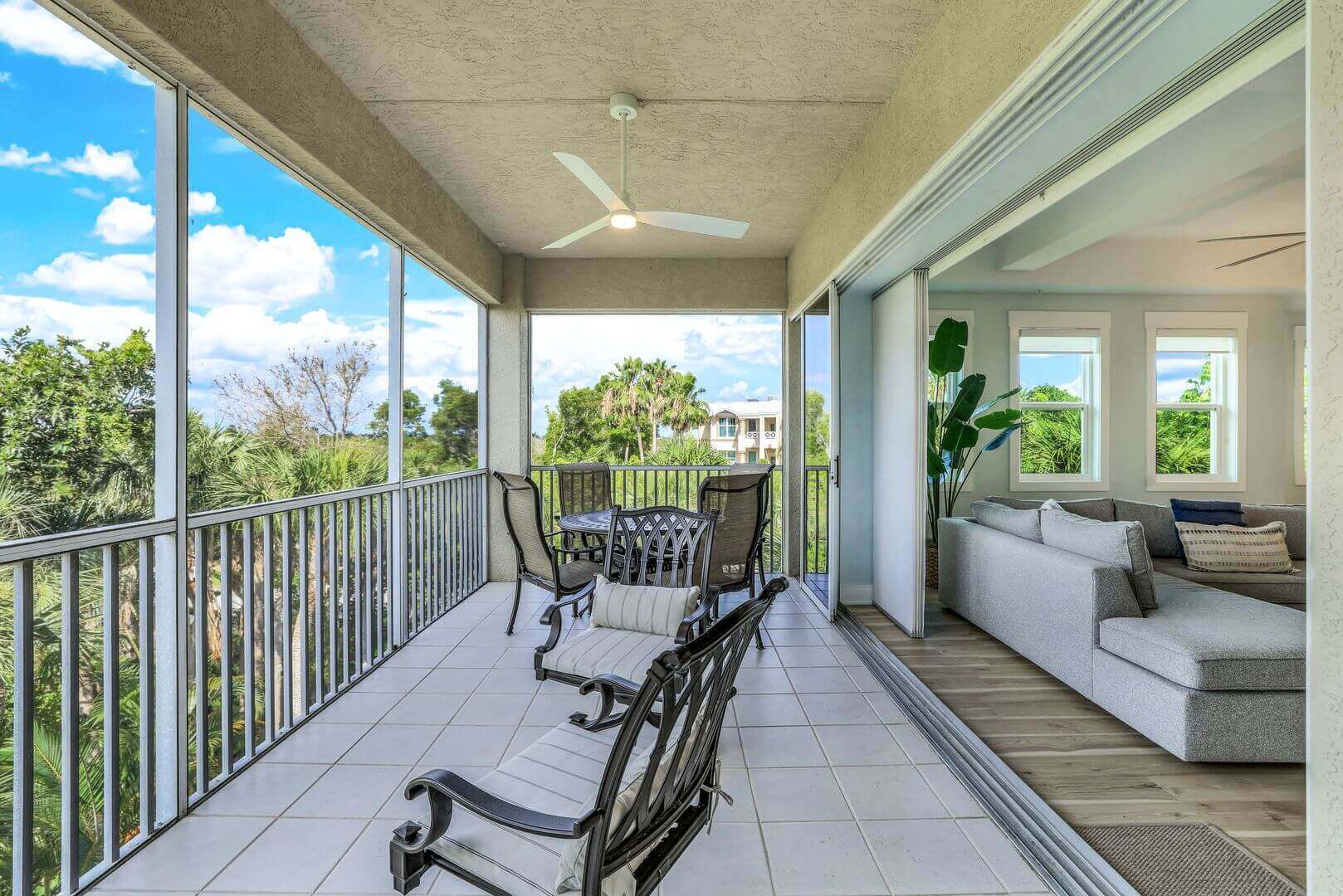 Spacious balcony with outdoor seating and view.
