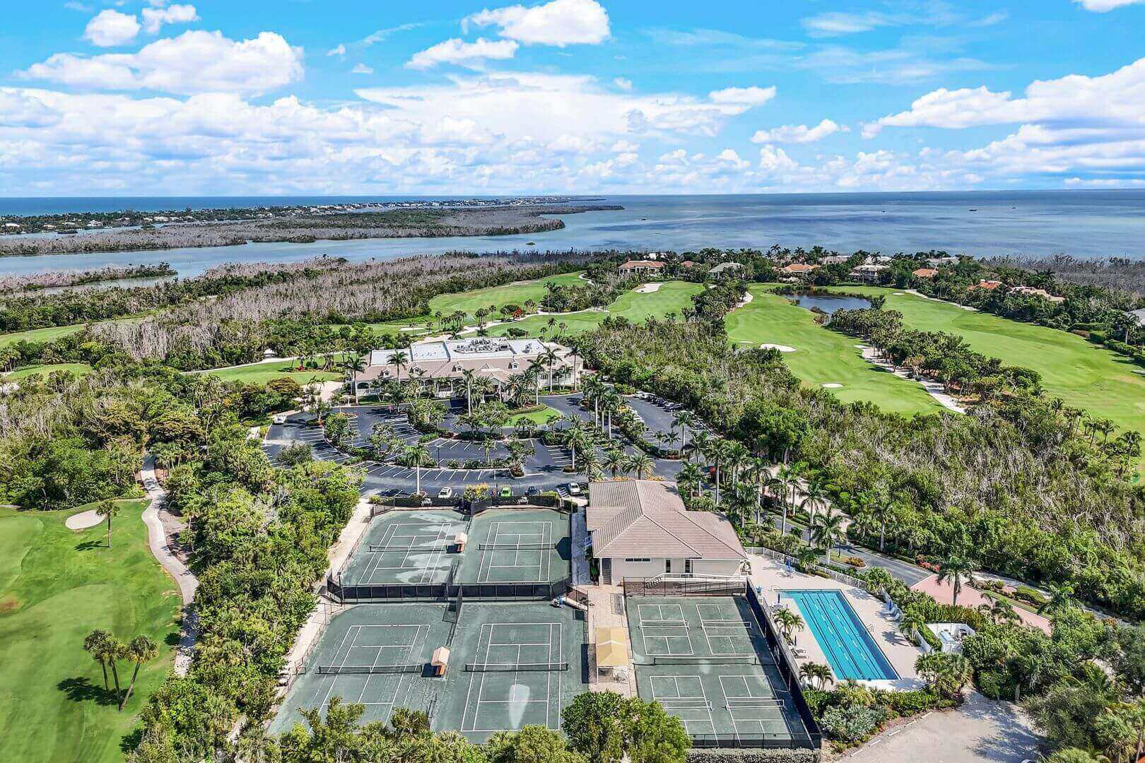 Aerial view of tennis courts by water.