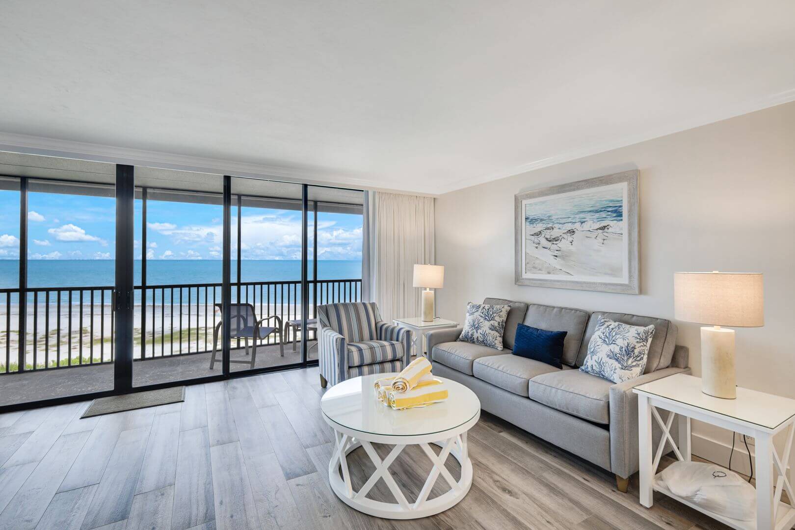 Beachfront living room with ocean view balcony.