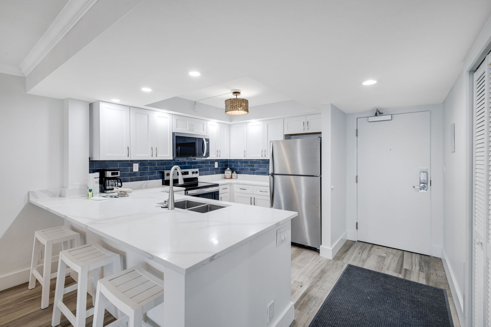 Modern kitchen with white cabinets and island.