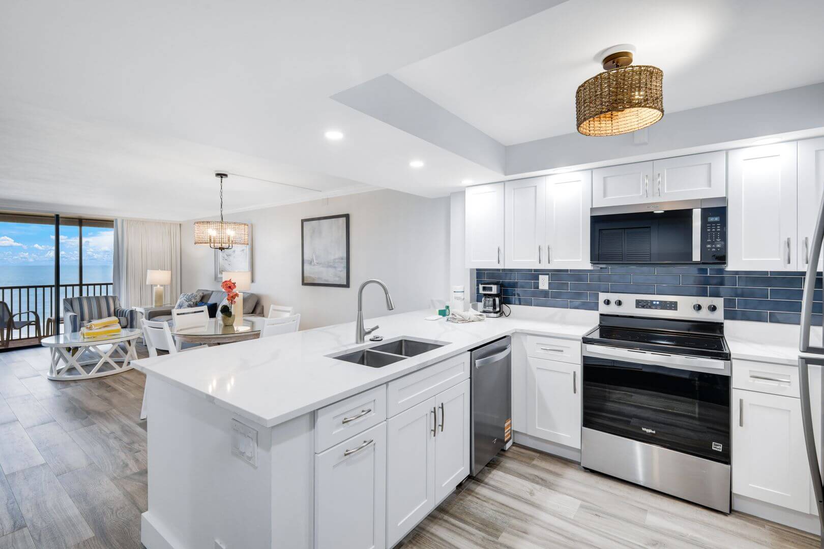 Modern kitchen and living area with ocean view.