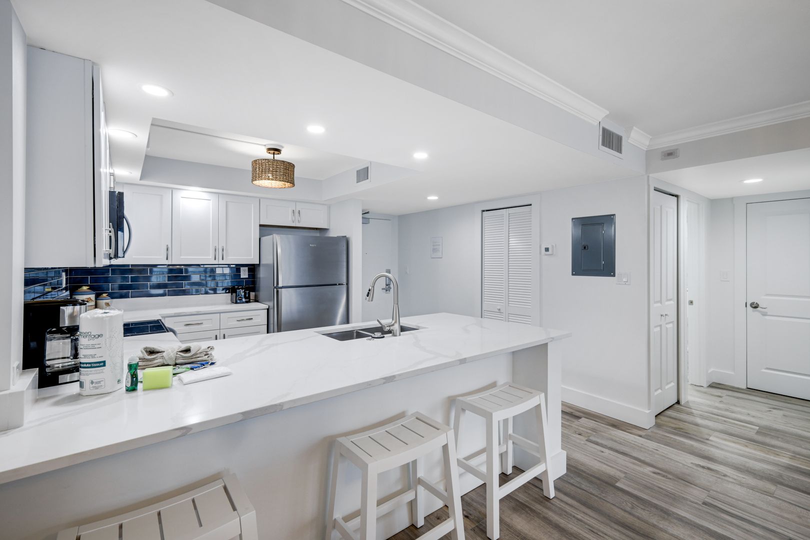Modern kitchen with white cabinets and island.
