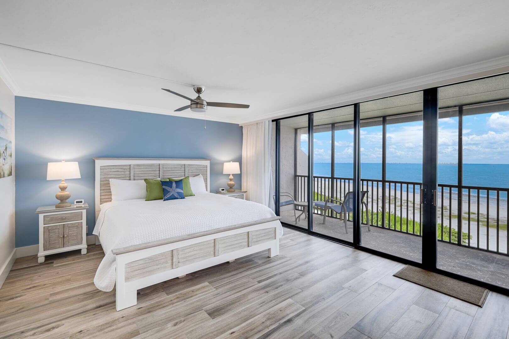 Beachfront bedroom with ocean view balcony.
