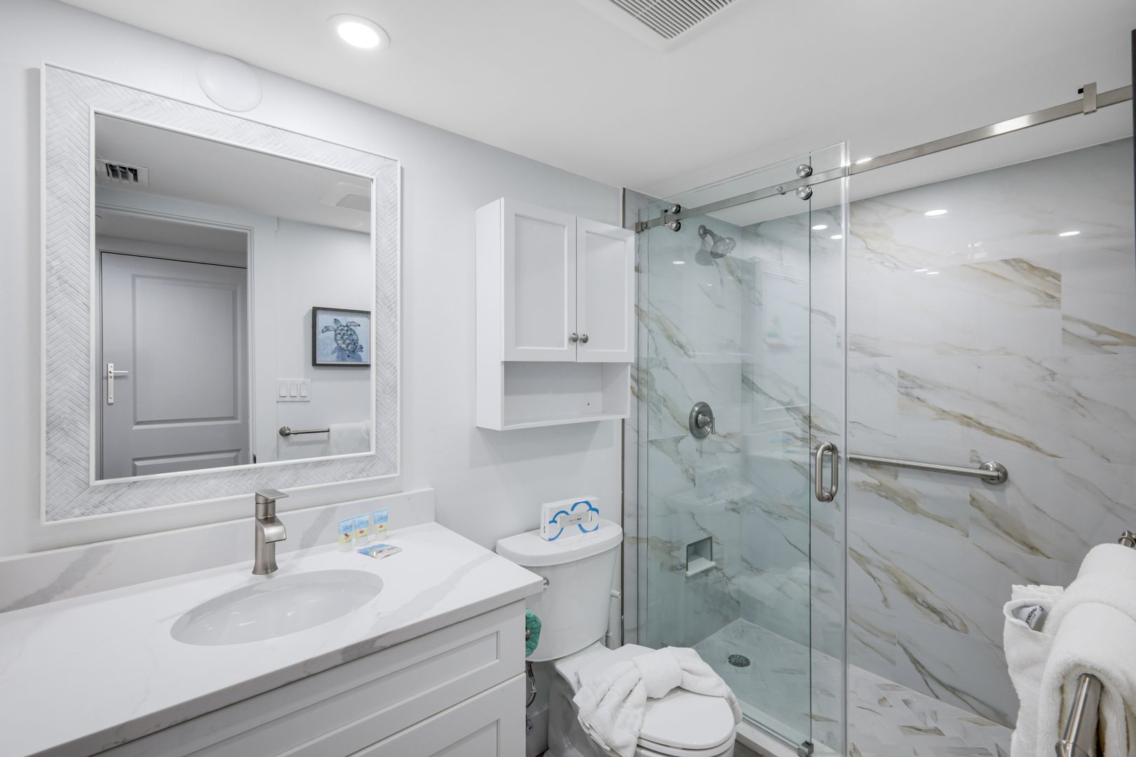 Modern bathroom with glass shower enclosure.