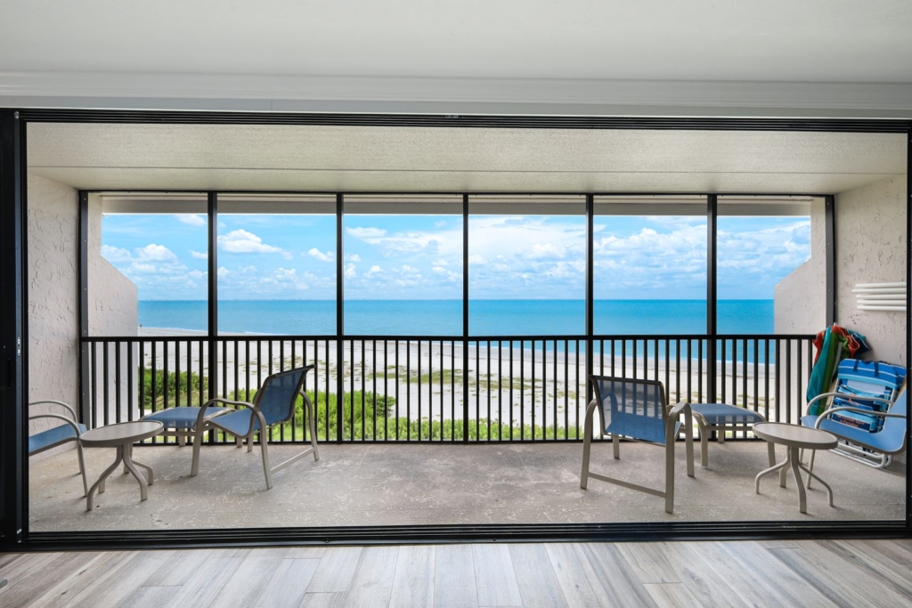 Balcony with ocean view and seating area.