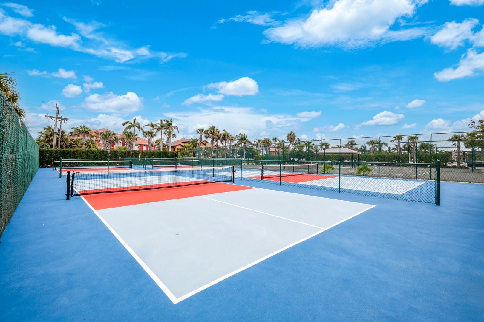 Outdoor tennis courts under a clear sky.