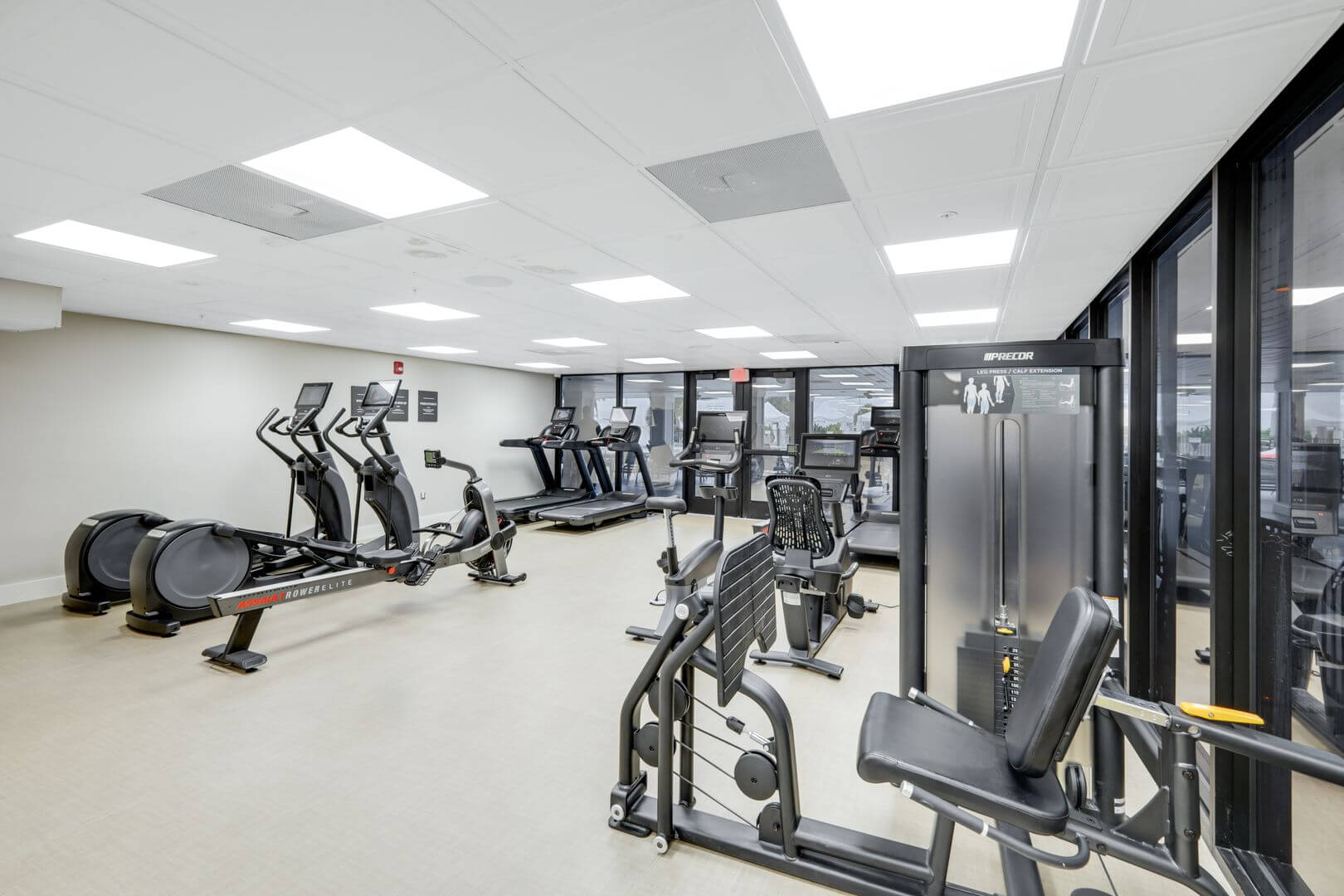 Modern gym with exercise equipment and machines.