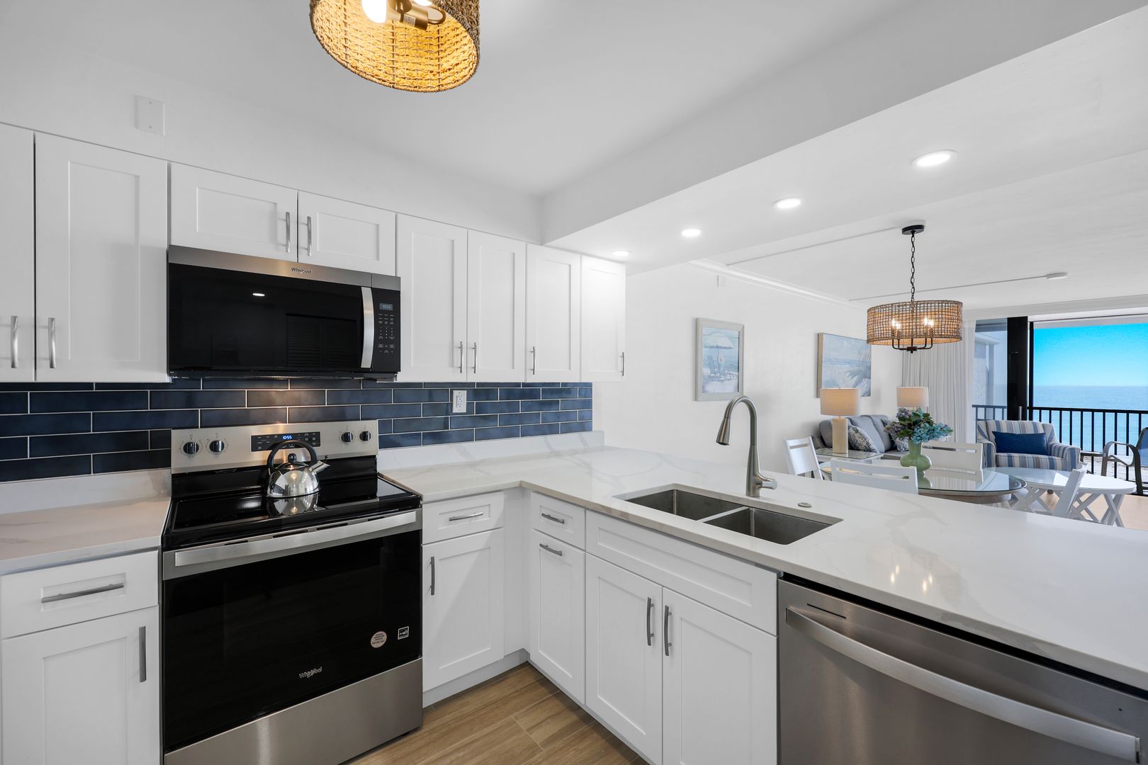 Modern kitchen with white cabinets and appliances.