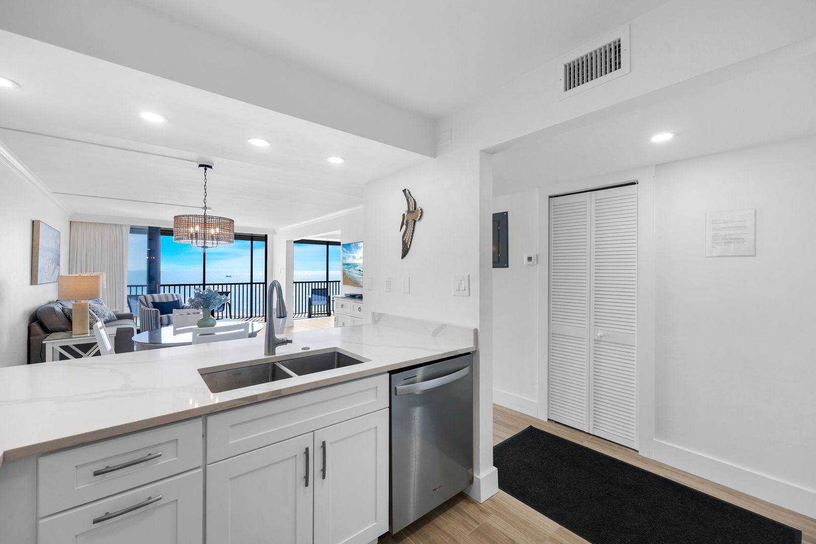 Modern kitchen and living area with view.