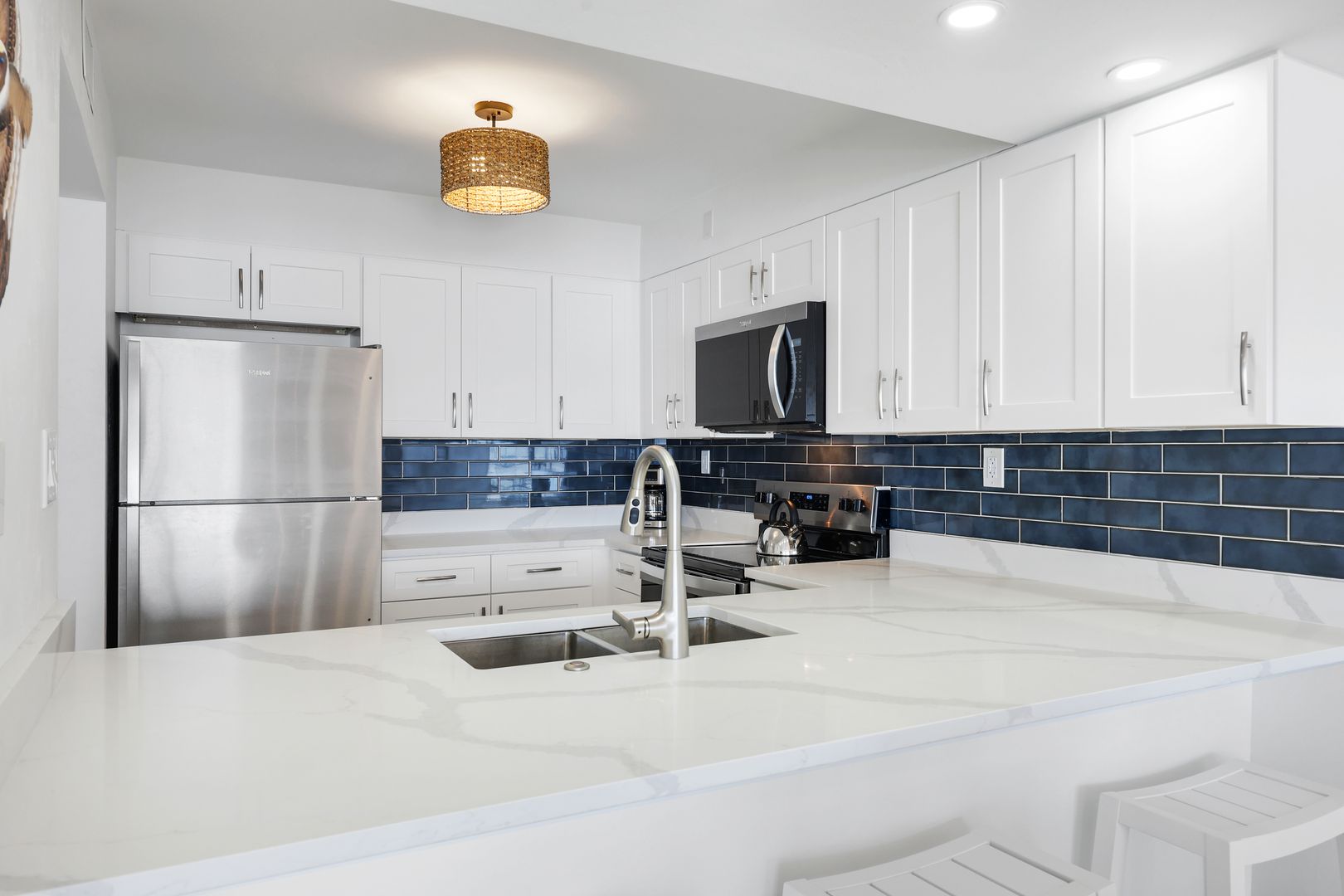 Modern kitchen with blue tile backsplash.