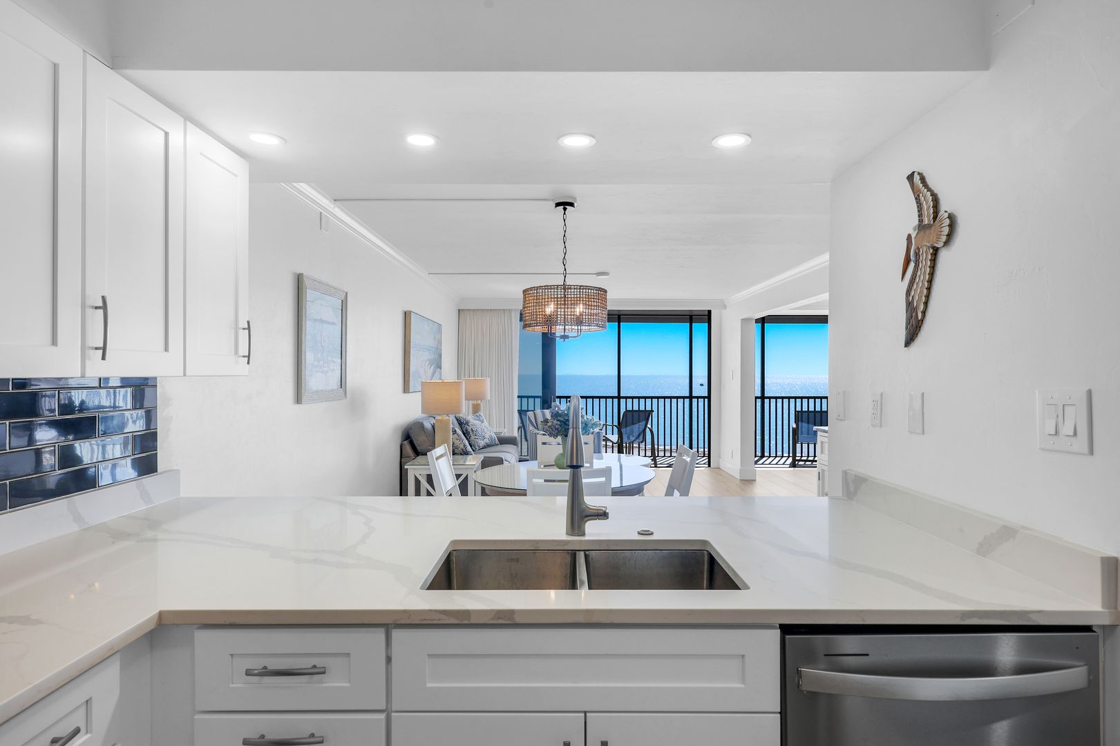 Modern kitchen with ocean view and decor.