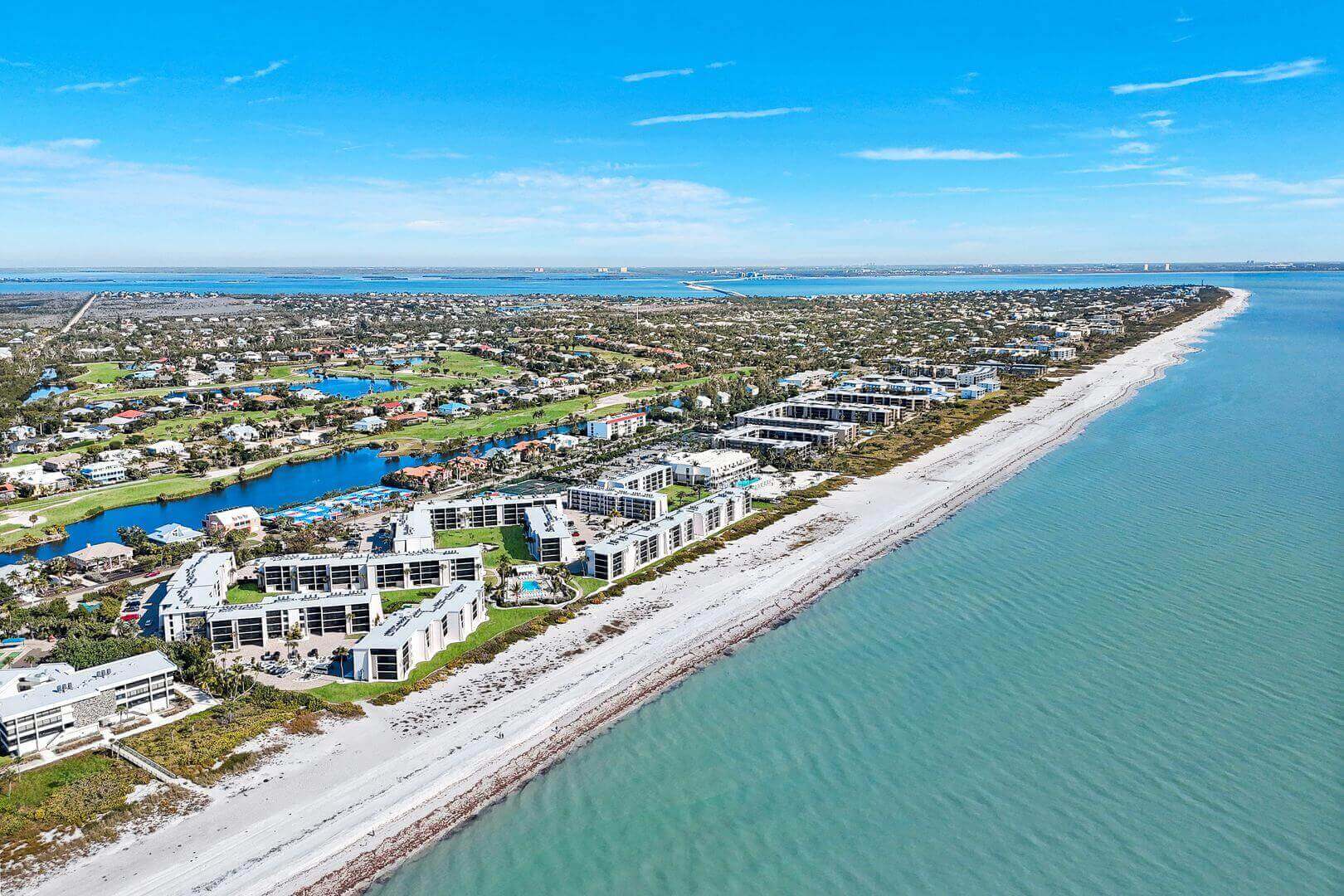 Aerial view of beachfront buildings and coastline.