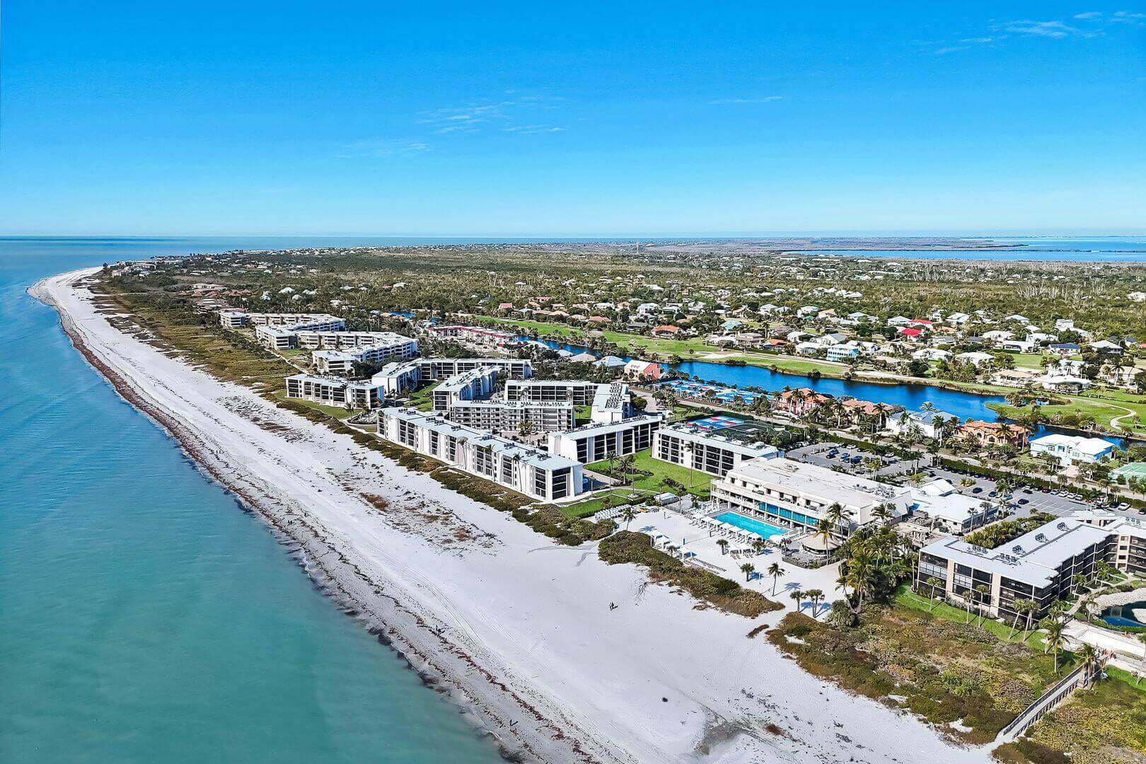 Aerial view of beachfront buildings and coastline.