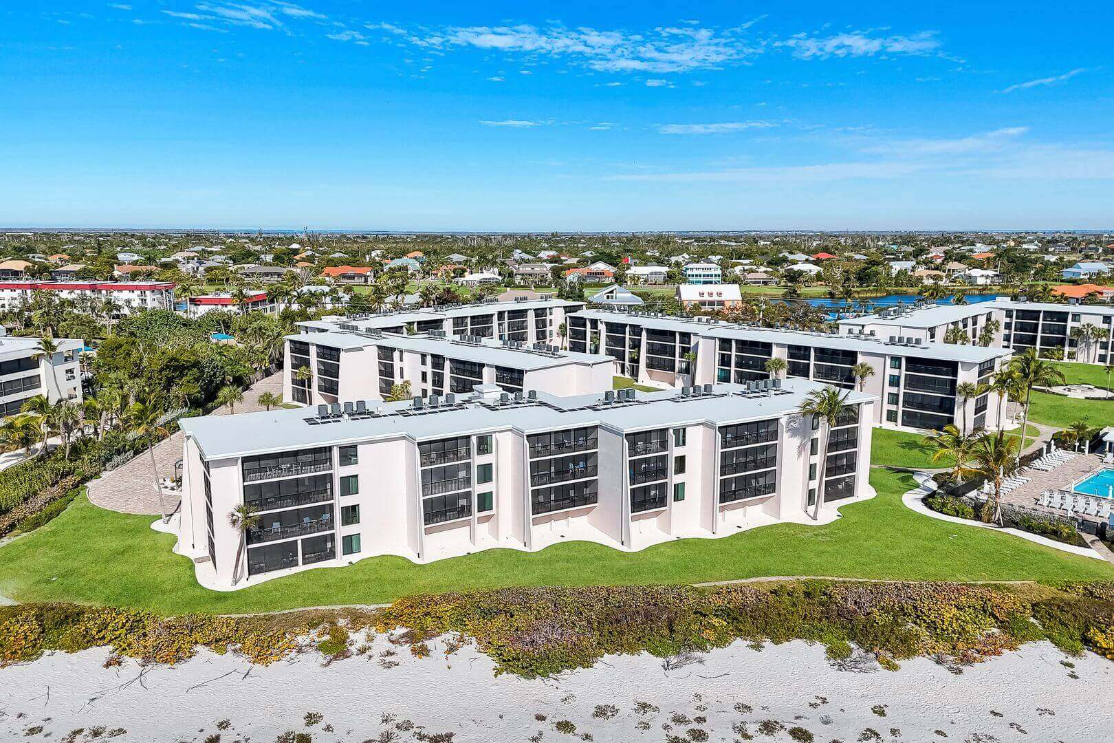 Beachfront apartment complex with scenic surroundings.